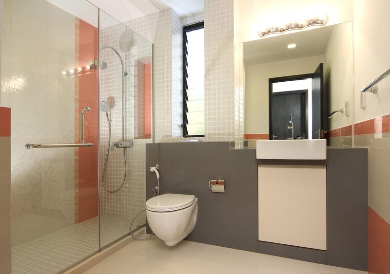 A bathroom with a toilet a sink and a walk in shower