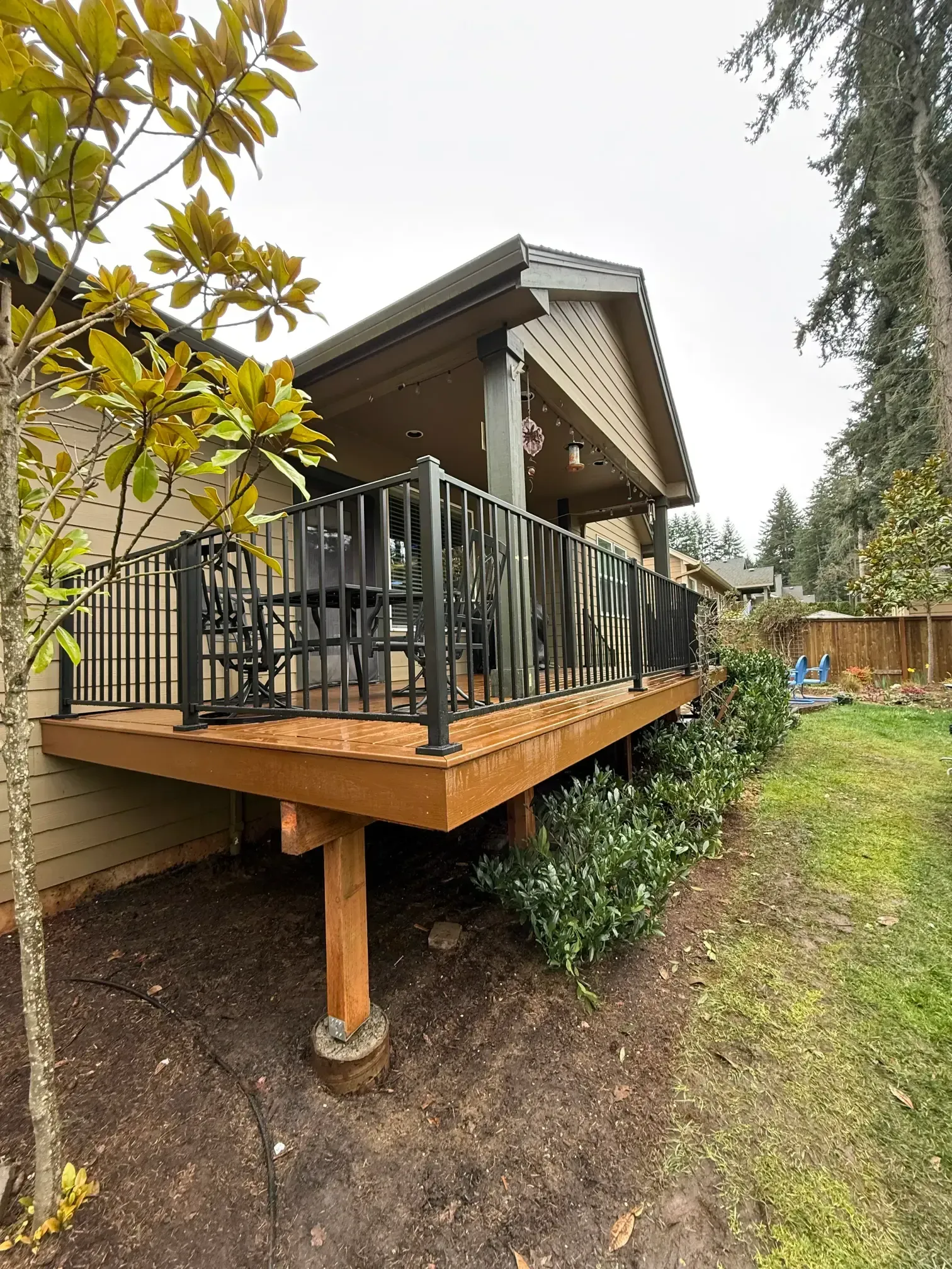 Side profile of a raised deck with a black railing system.