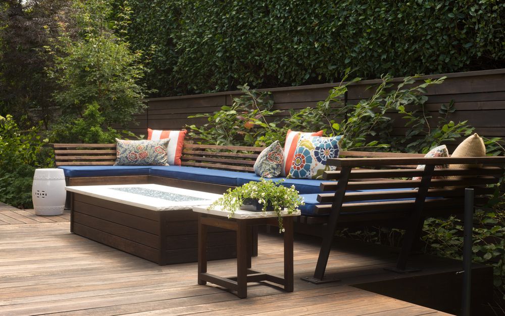 A wooden deck with a couch and a table on it