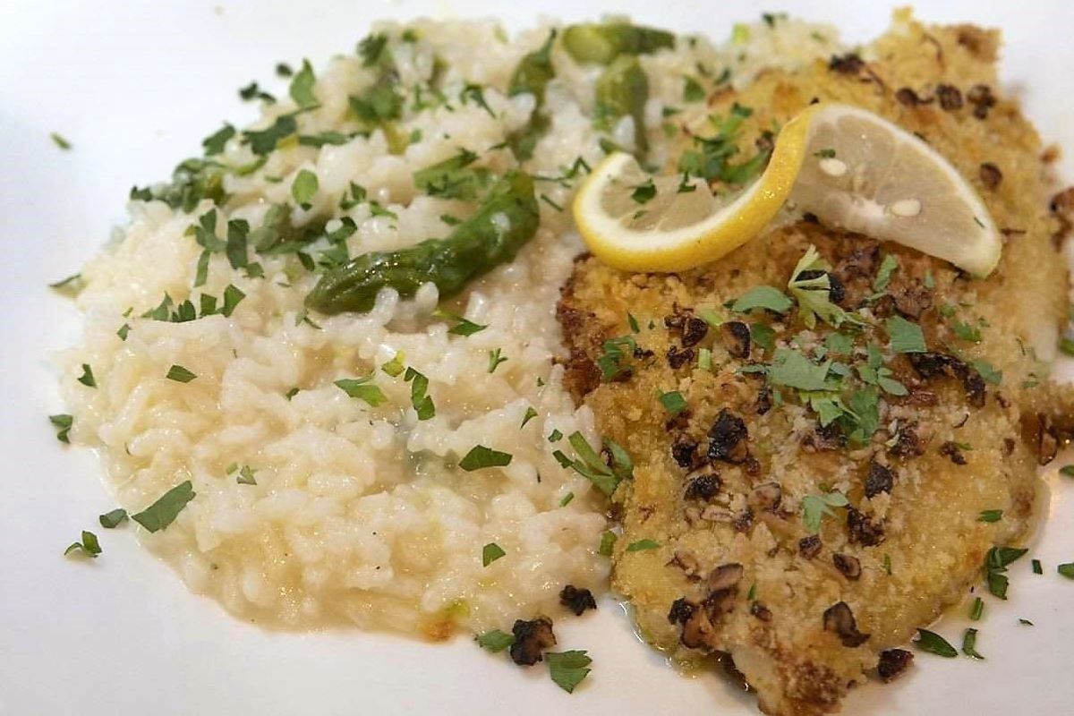 A plate with breaded sole and risotto
