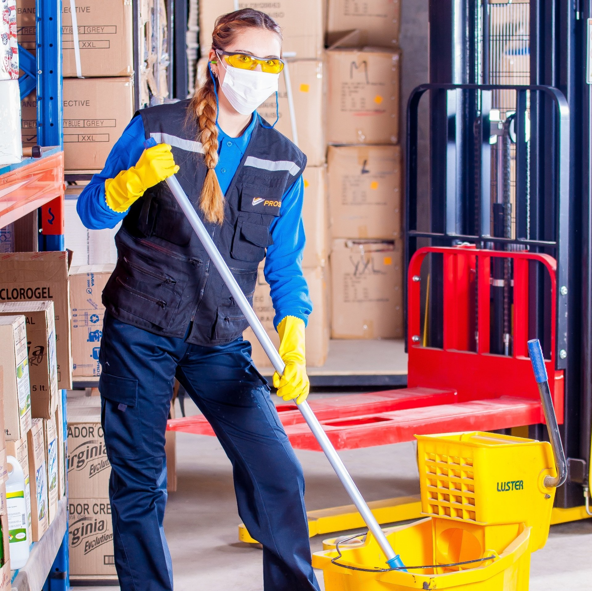 A janitorial employee wearing a mask