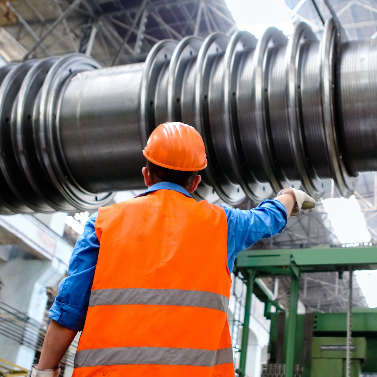 A manufacturing employee looking at machinery