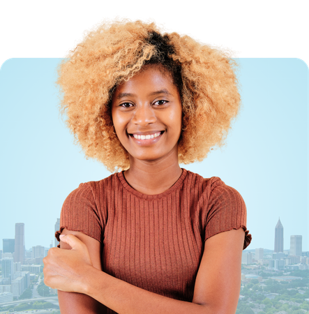 Woman smiling with eyes closed, hands on cheeks; city skyline backdrop.
