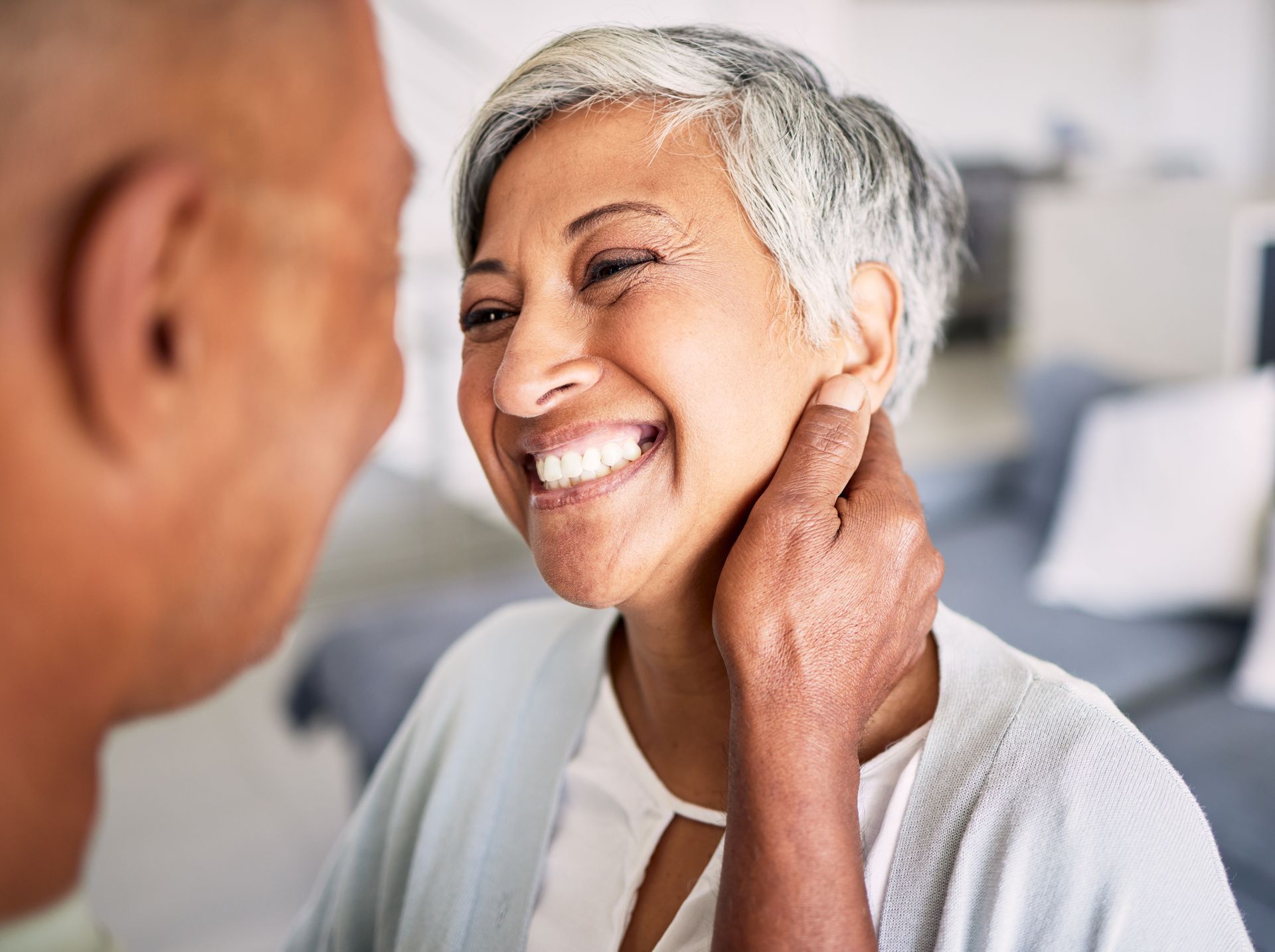 Happy senior woman embracing family