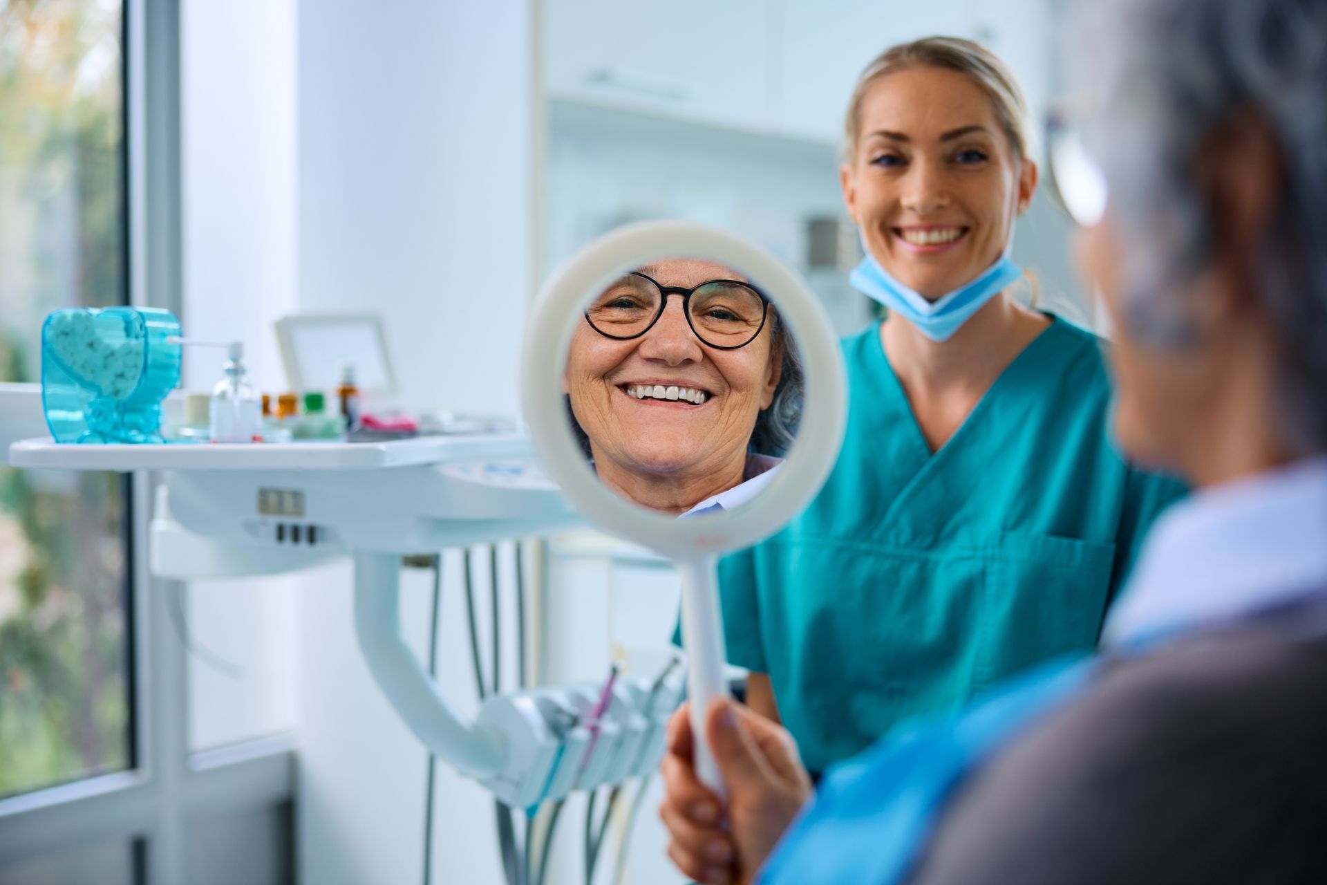 Senior woman admiring her smile in a mirror