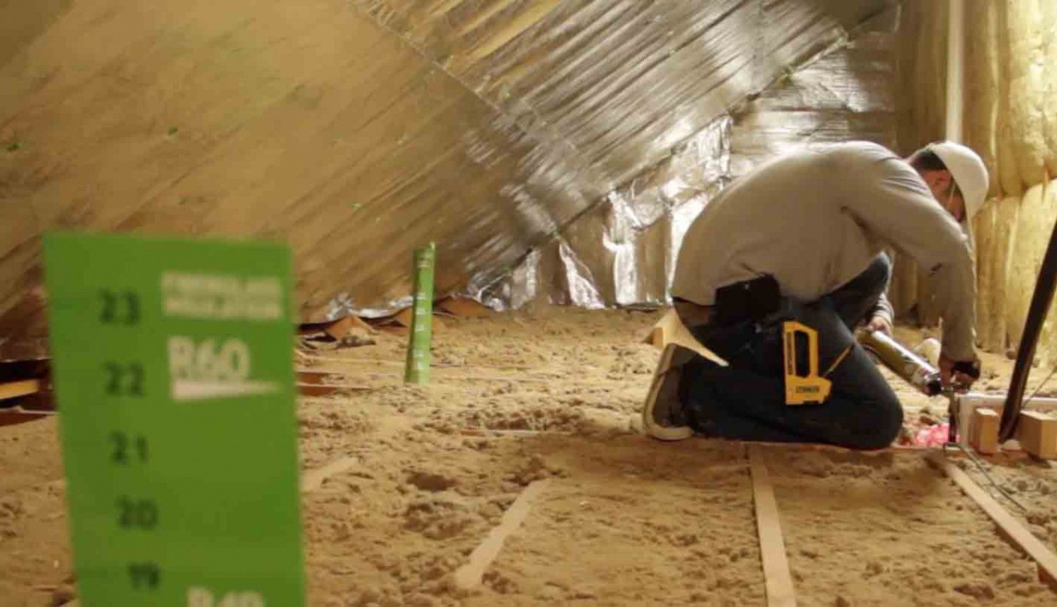 Man in Attic Installing Insulation