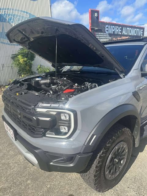 The Engine of a Red Car is Shown With the Hood Open — Empire Automotive In Portsmith, QLD