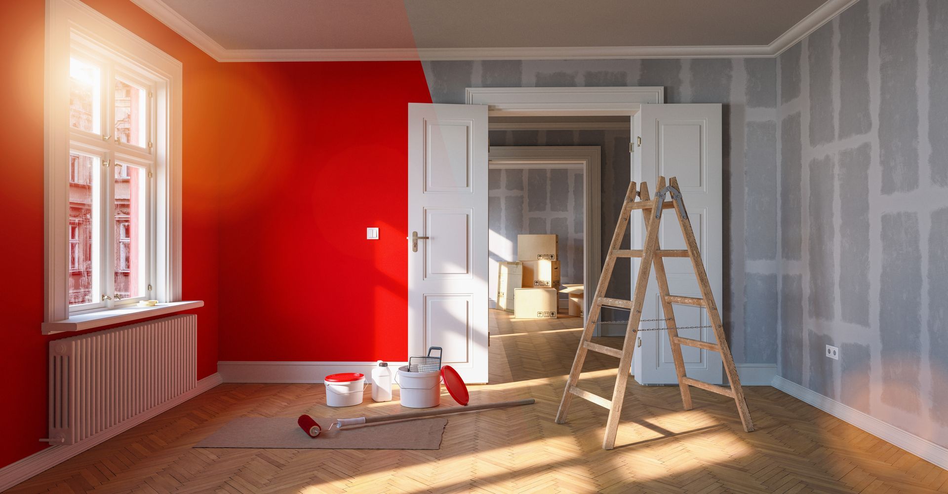 Stanza in fase di ristrutturazione: una parete rossa, le altre pareti grigie, con materiale per la pittura e scala.