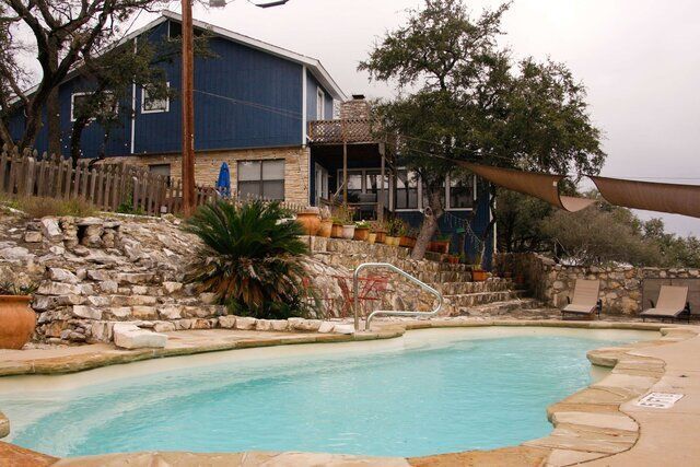 A large swimming pool in front of a house