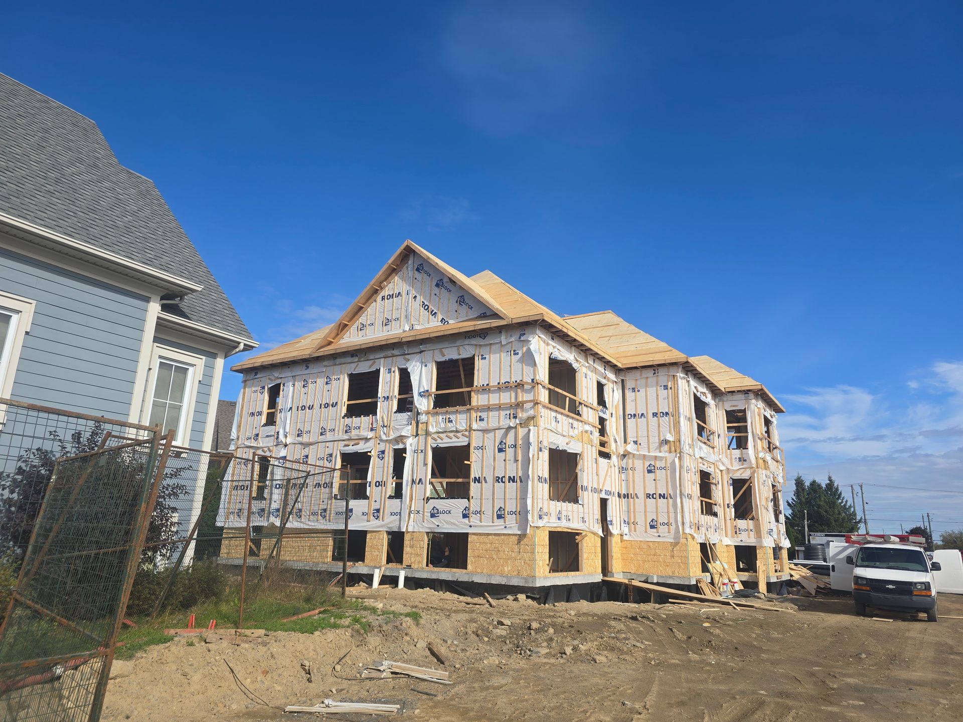 A large building is being built next to a smaller building.