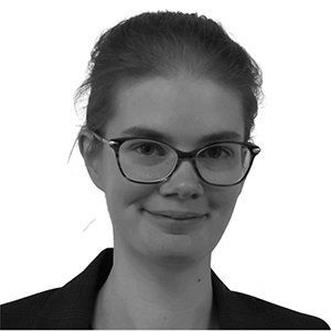 Portrait of a person wearing glasses, looking at the camera with a slight smile.