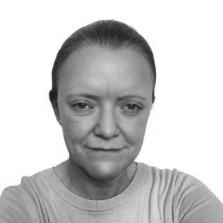 Black-and-white head-and-shoulders portrait of a person facing the camera with a neutral expression.