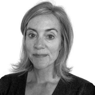 Black-and-white headshot of a person with shoulder-length hair, neutral expression, on a plain background