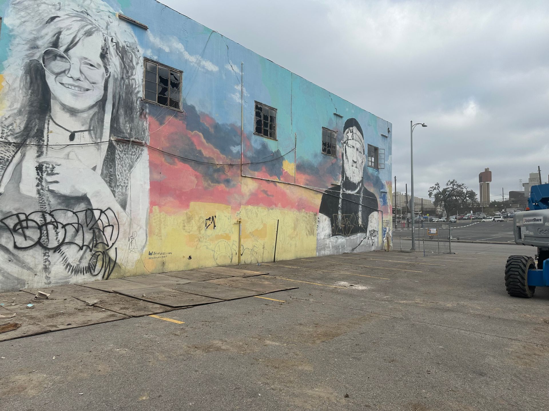 A large mural of a woman and a man on the side of a building.
