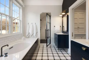 Finished bathroom with granite counter and marble floor