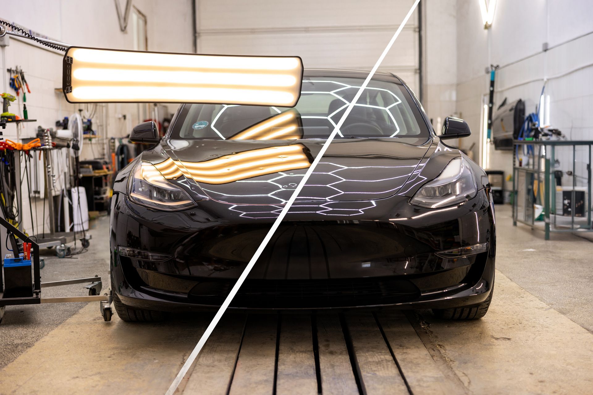 Front view of a dark sedan in an auto shop, split-screen showing polished and unpolished paint.