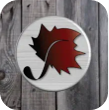 Red sycamore leaf logo on a white circular sign against weathered gray wood.