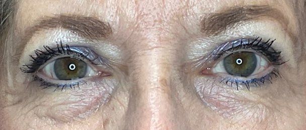 Close-up of a person’s eyes with dark eyeliner and mascara, looking straight ahead.