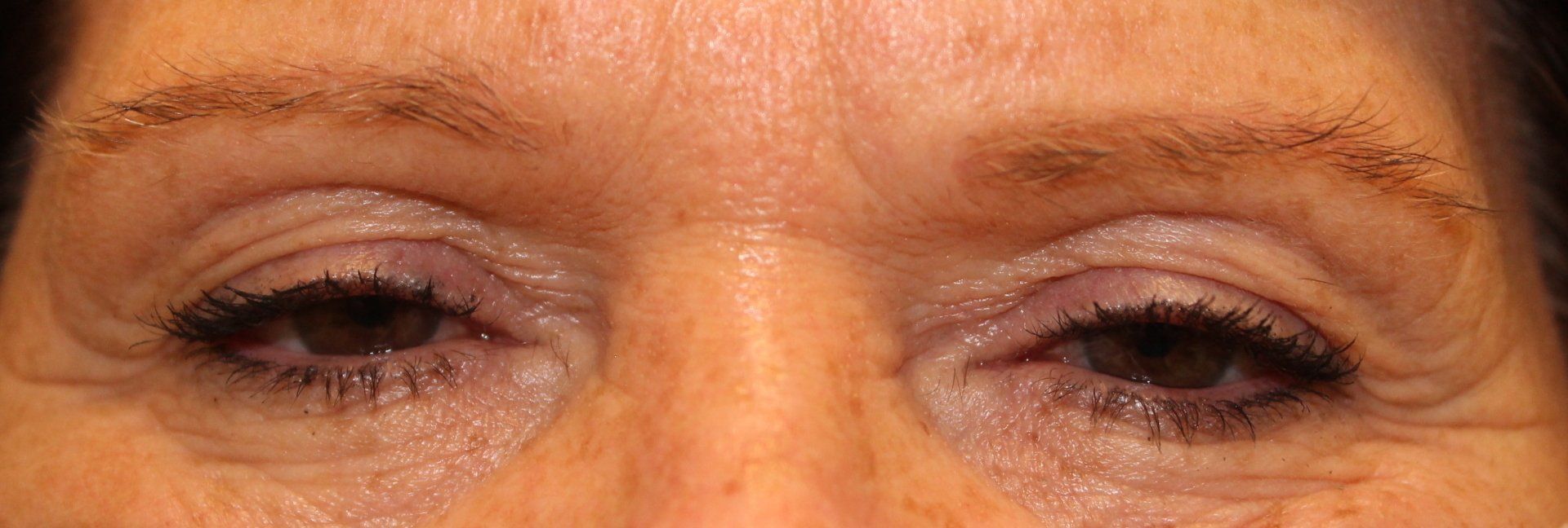 Close-up of a person’s eyes with dark eyeliner and slightly wrinkled skin