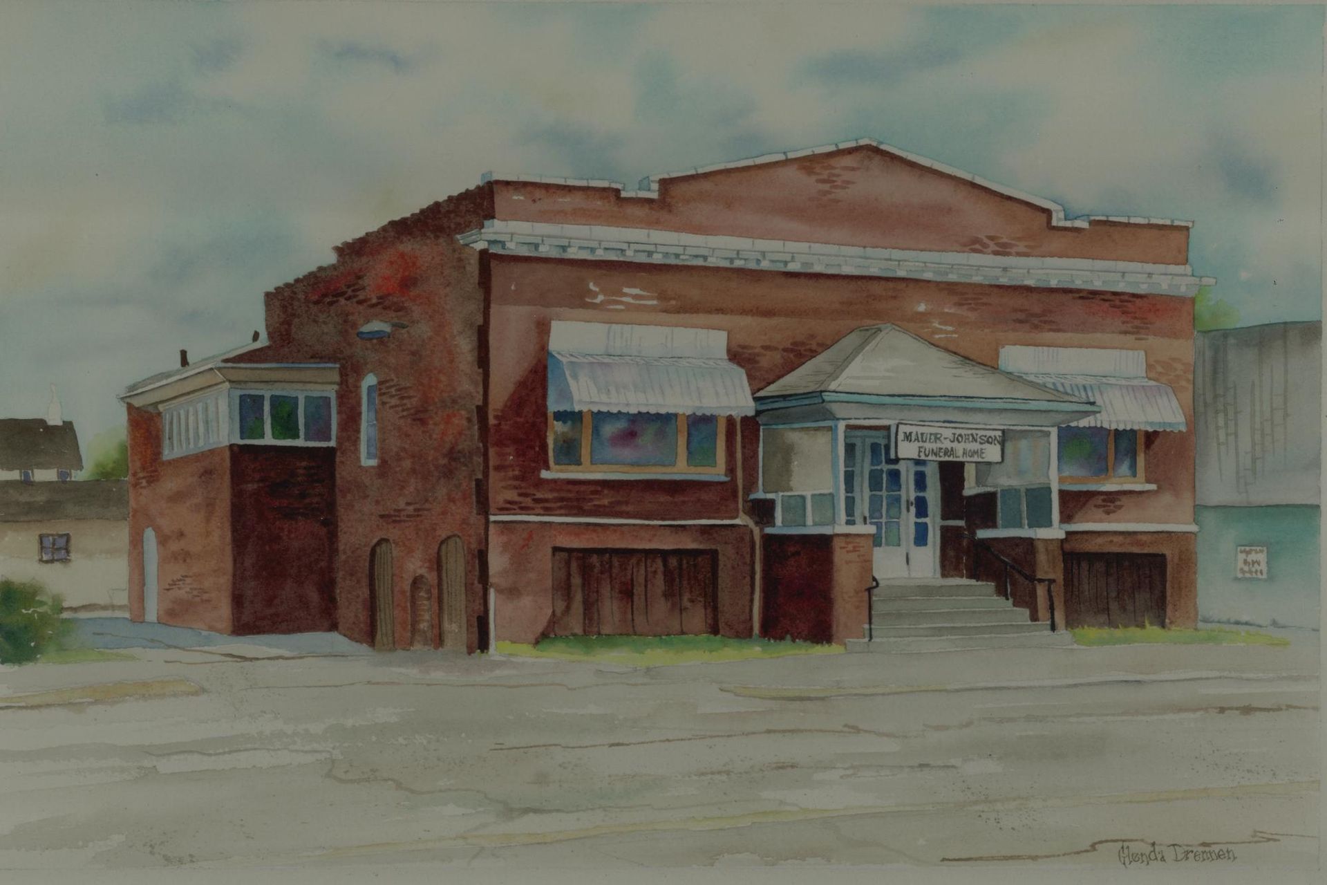 Watercolor of a red-brick train station with blue awnings on a snowy, empty street.