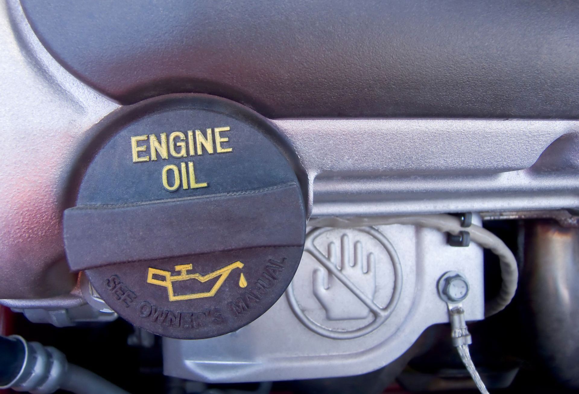 A close up of an engine oil cap on a car