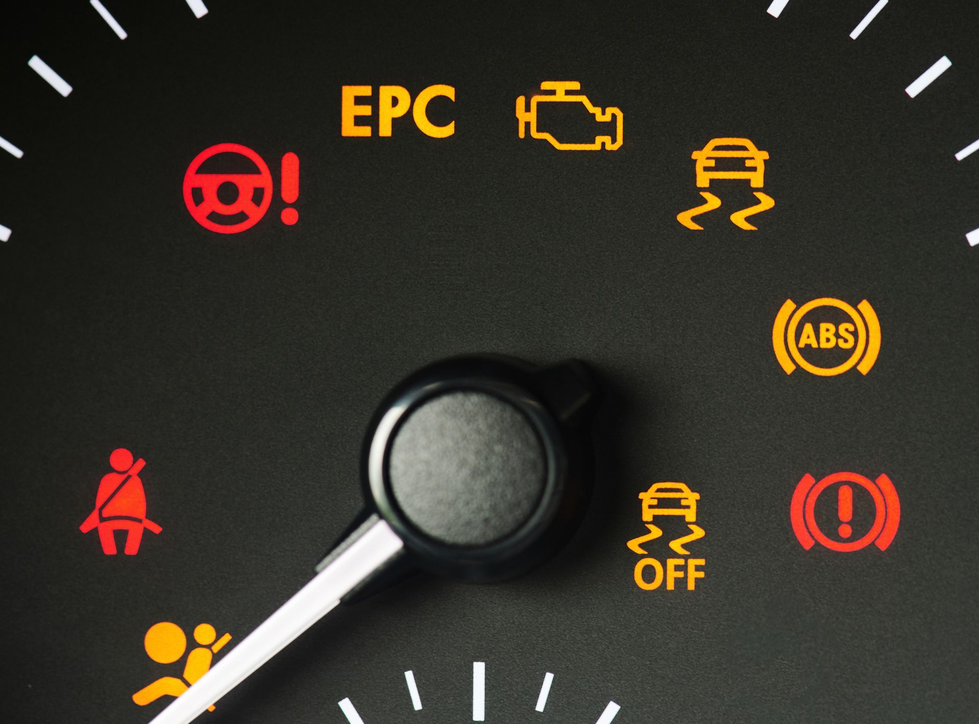A close up of a car dashboard with various warning lights including abs and epc