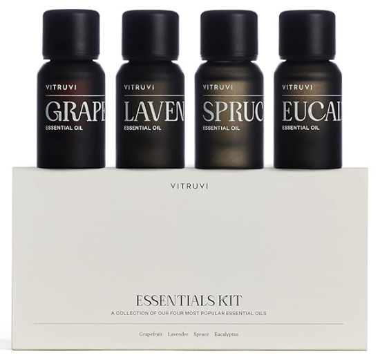 Essential oils gift set with four black bottles in a white box