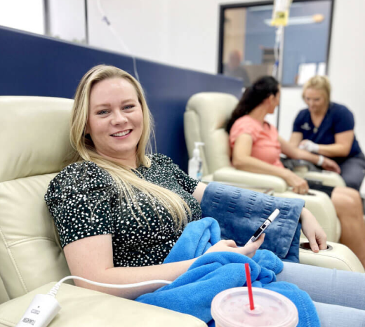 woman in a chair getting iv therapy