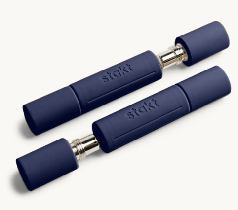Two navy blue metal cigarette cases with silver tips on a white background