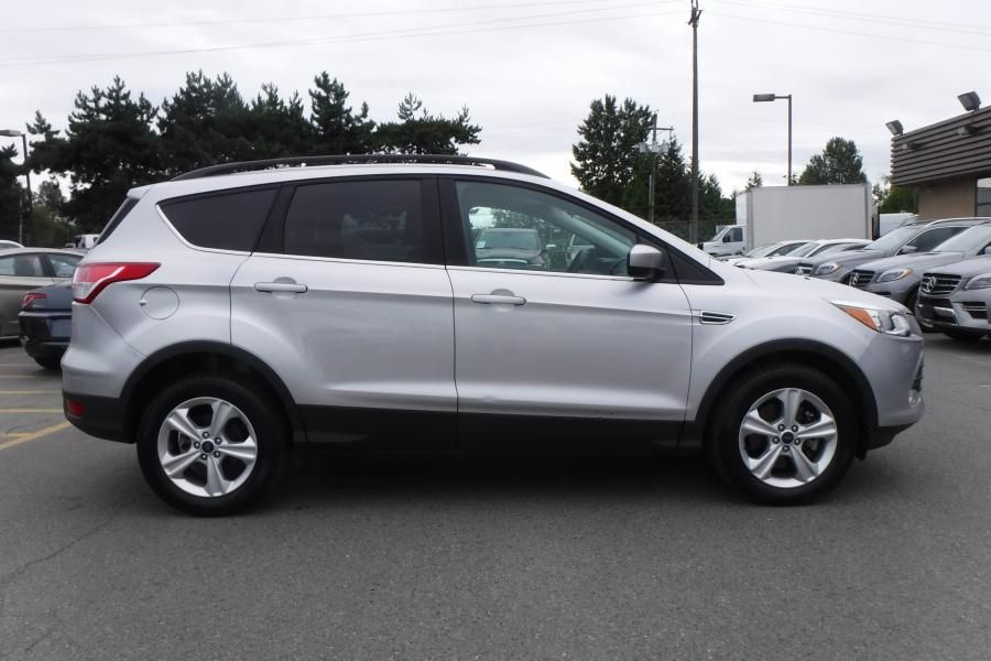 Silver Ford Escape SUV parked outdoors on a cloudy day.