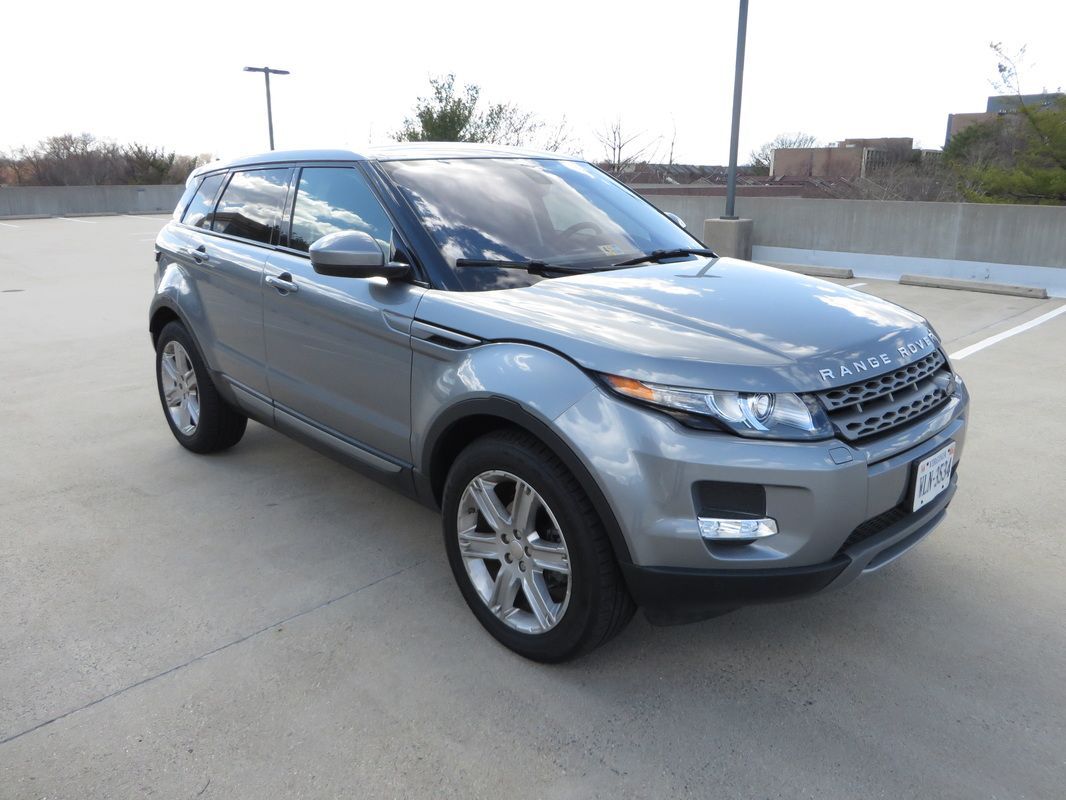 Silver Range Rover Evoque SUV parked on a rooftop parking lot.