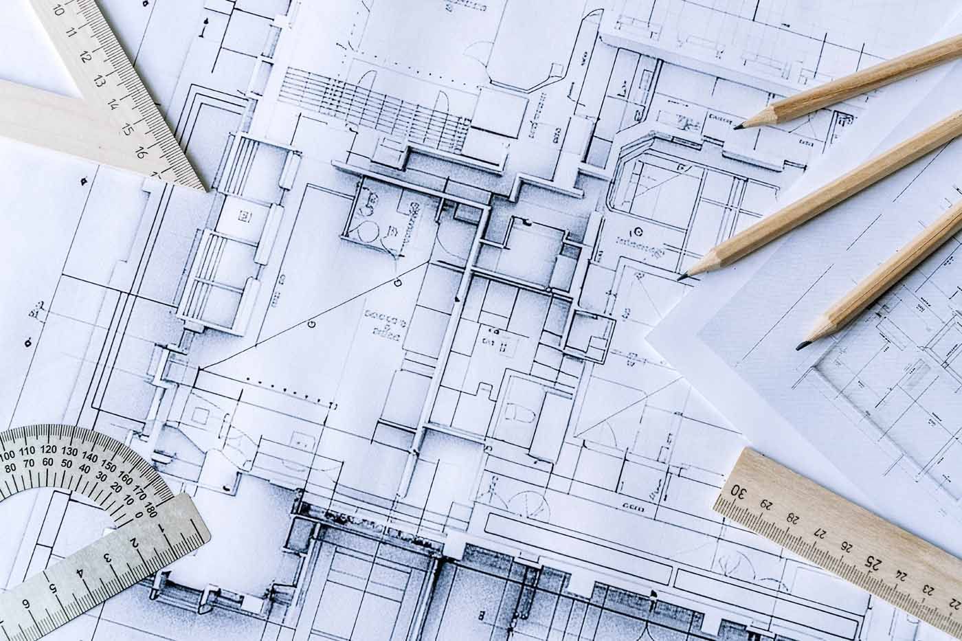 A drawing of a building with a ruler and pencils on it.
