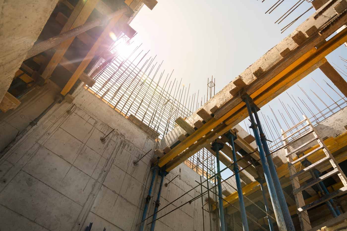 The sun is shining through the ceiling of a building under construction.