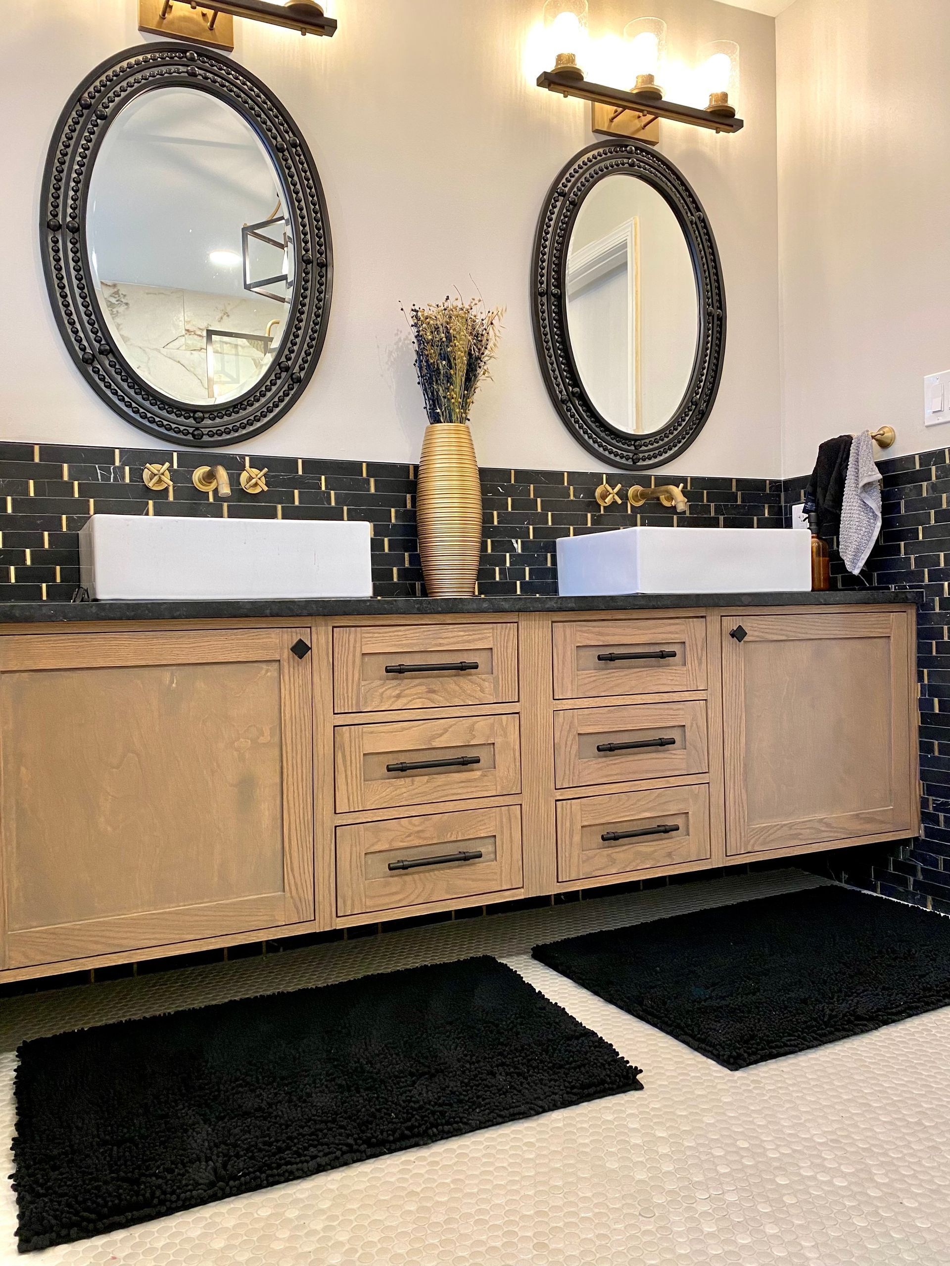A bathroom with two sinks and two mirrors.