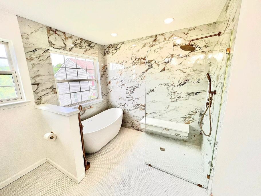 A bathroom with a tub , shower and window.