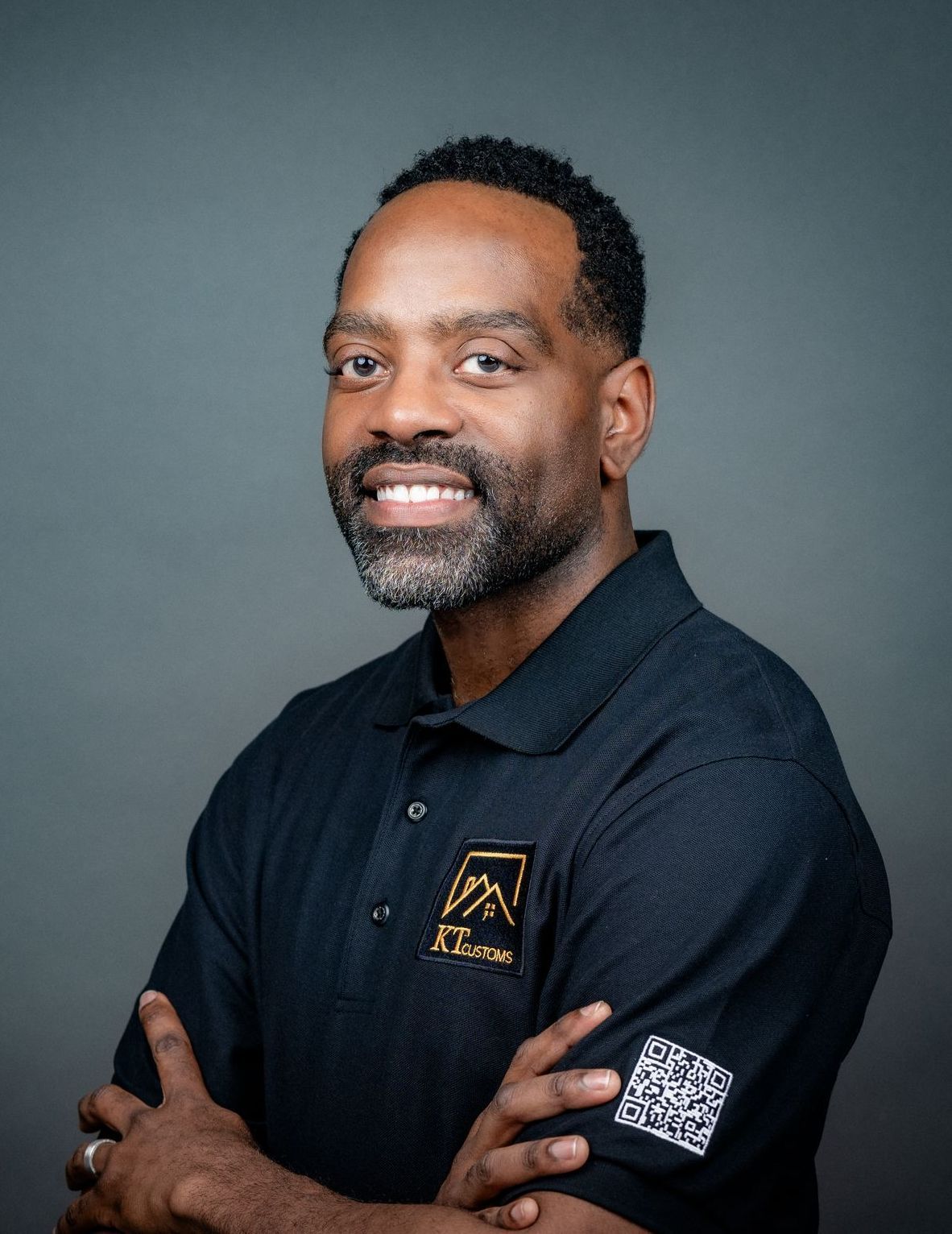Owner, Kevin, smiling with his arms crossed

