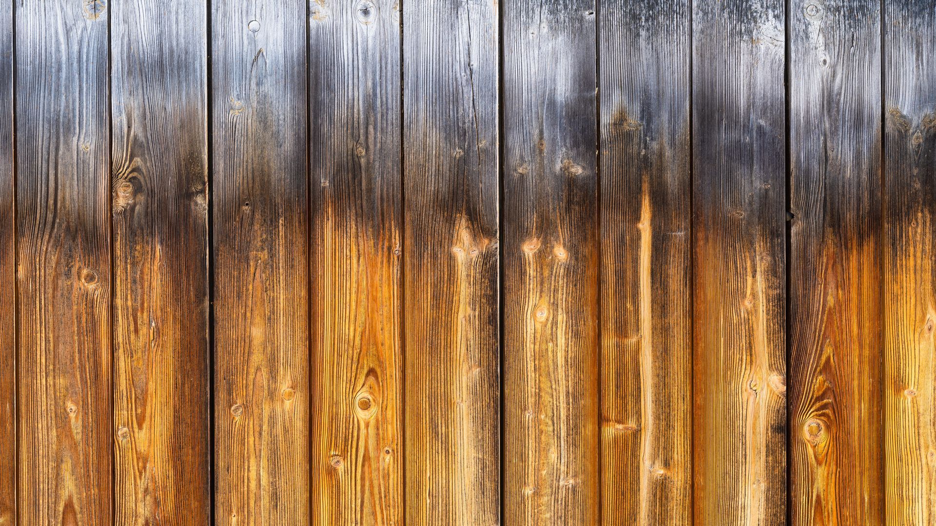A close up of a wooden fence with a gray border.