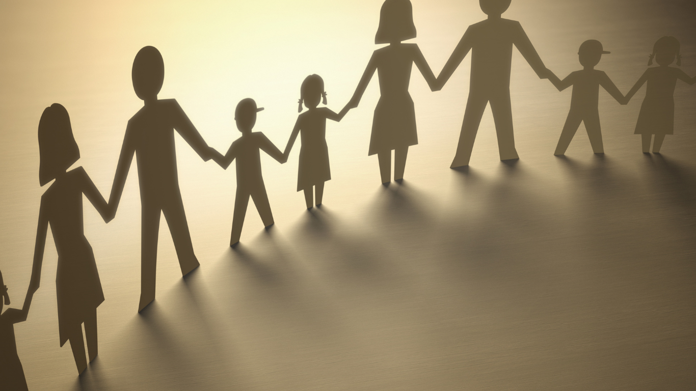 Silhouetted people holding hands in a circle, casting long shadows on a sunlit floor.