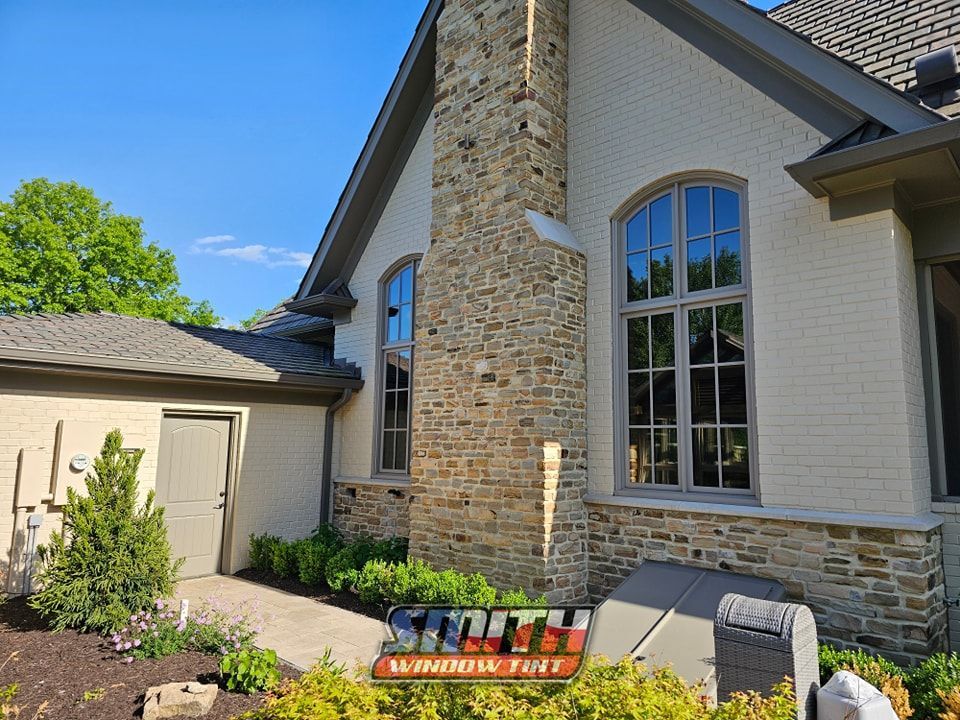 A house with a lot of windows and a chimney