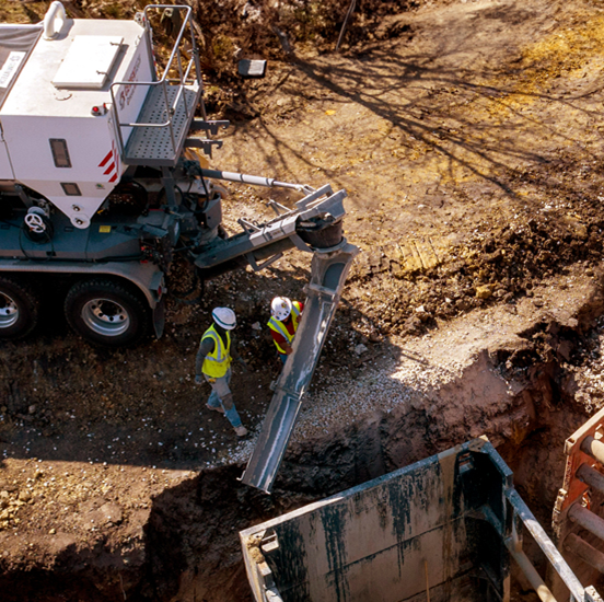 An aerial view of a construction site with workers and a truck