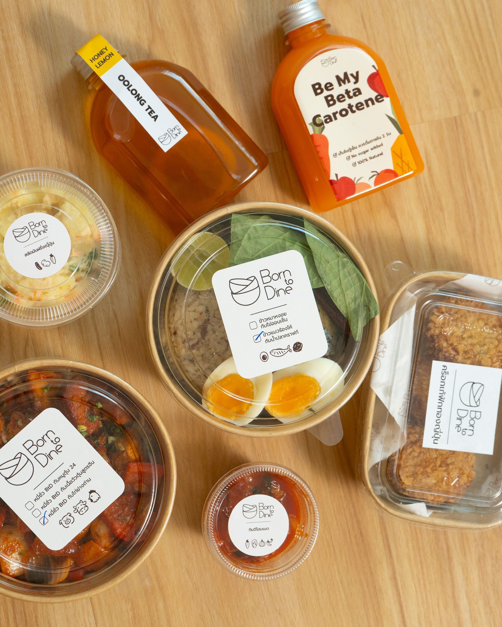 Various food items including bowls, containers, and bottles on a wooden surface.