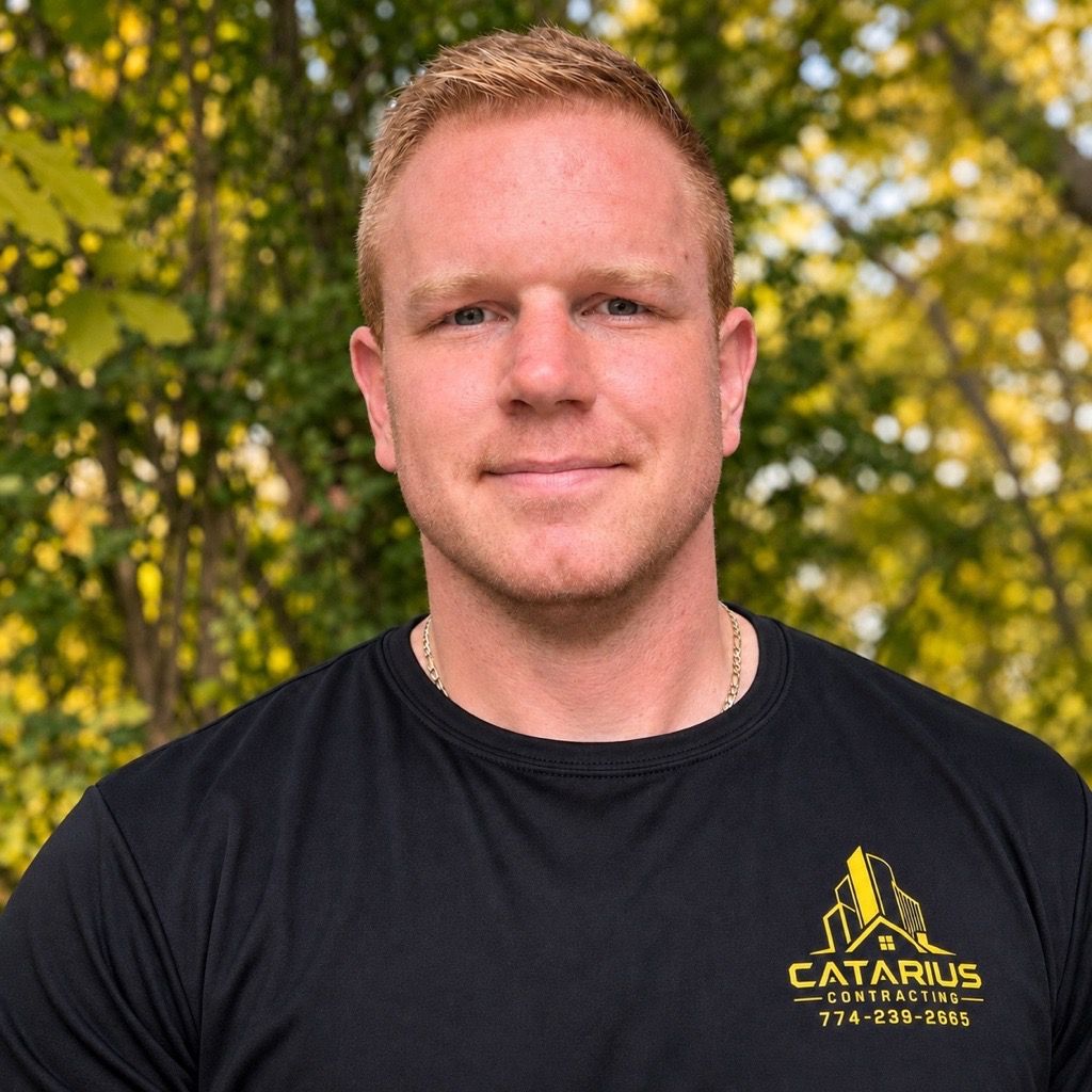 Portrait of a man in a black CATARIUS T-shirt outdoors with trees in the background