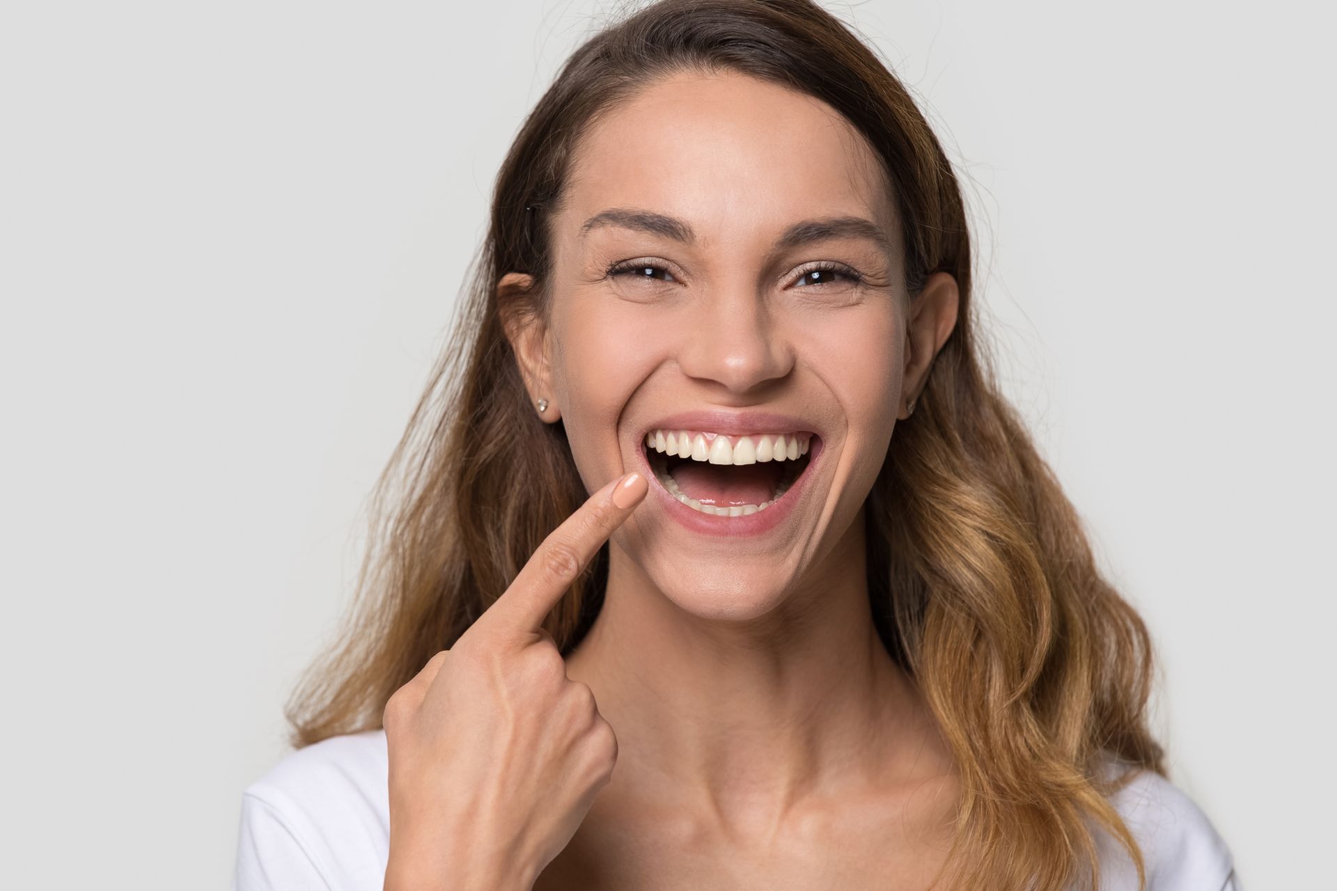 Woman enjoying her smile, highlighting root canal therapy results and overall oral wellness.