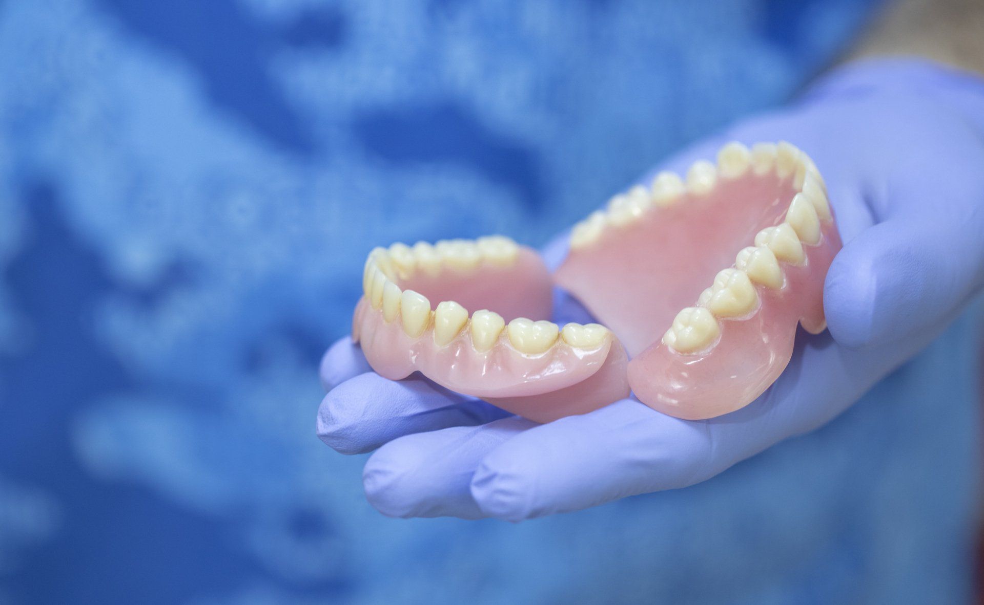 Dentist Holding Dentures | Redmond, OR | Highland Family Dental Dentist Holding Dentures | Redmond, OR | Highland Family Dental