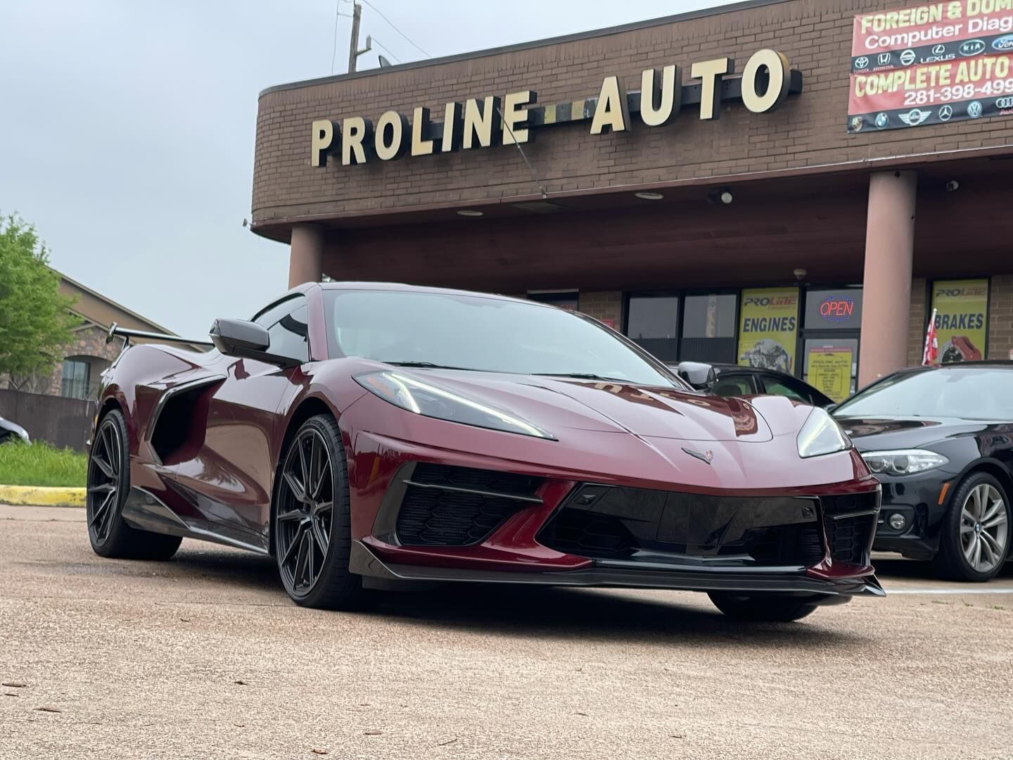 Burgundy Corvette parked in front of Proline Auto repair shop. | Proline Auto