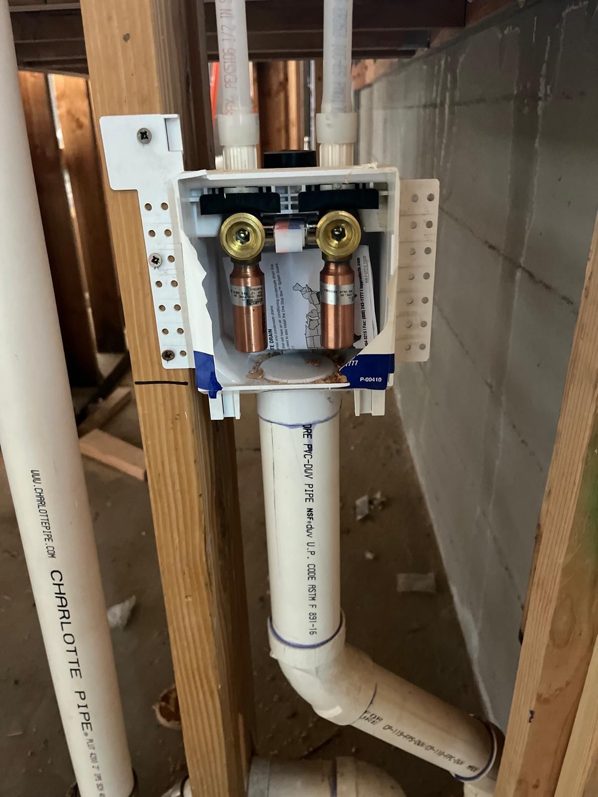 A box with copper pipes inside of it that says ' pvc ' on it