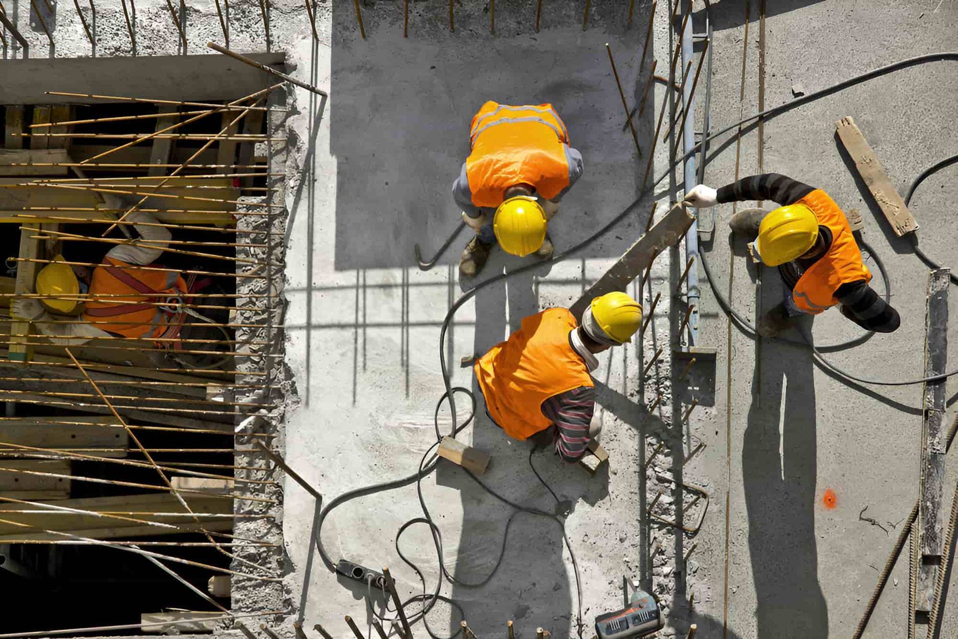 A Group Of Construction Workers Are Working On A Construction Site — JGA Concreting Pty Ltd In Berrimah, NT