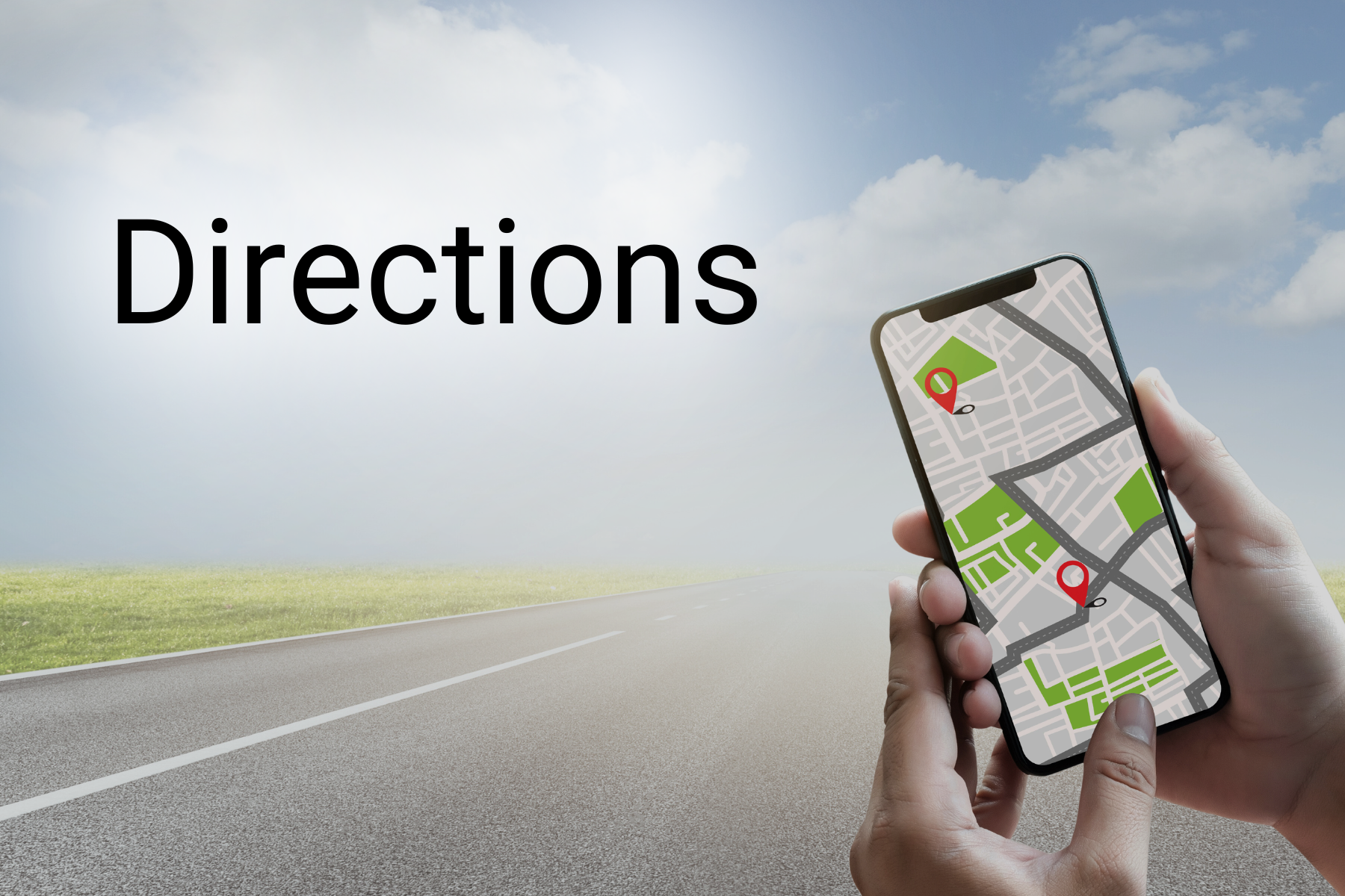 Hand holding a smartphone map beside the word “Directions” on an open road