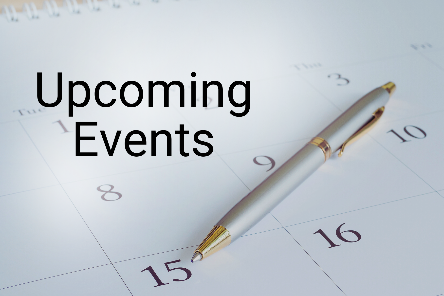 Upcoming Events on a calendar with a silver pen resting diagonally across the dates