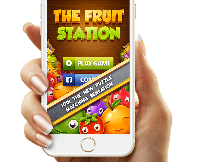 A person is holding a cell phone that says the fruit station